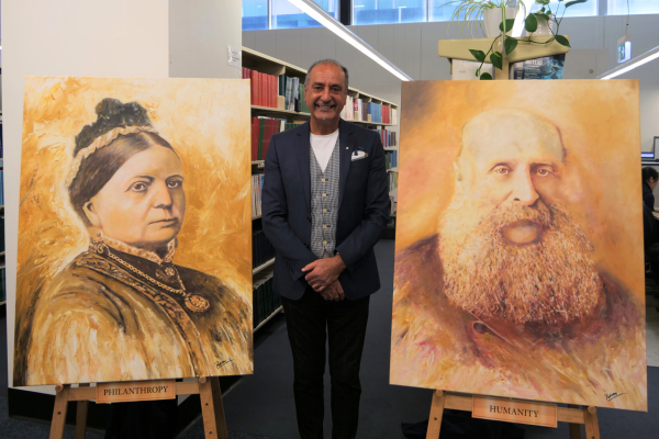 Picture of the artist George Petrou OAM with the two new portraits